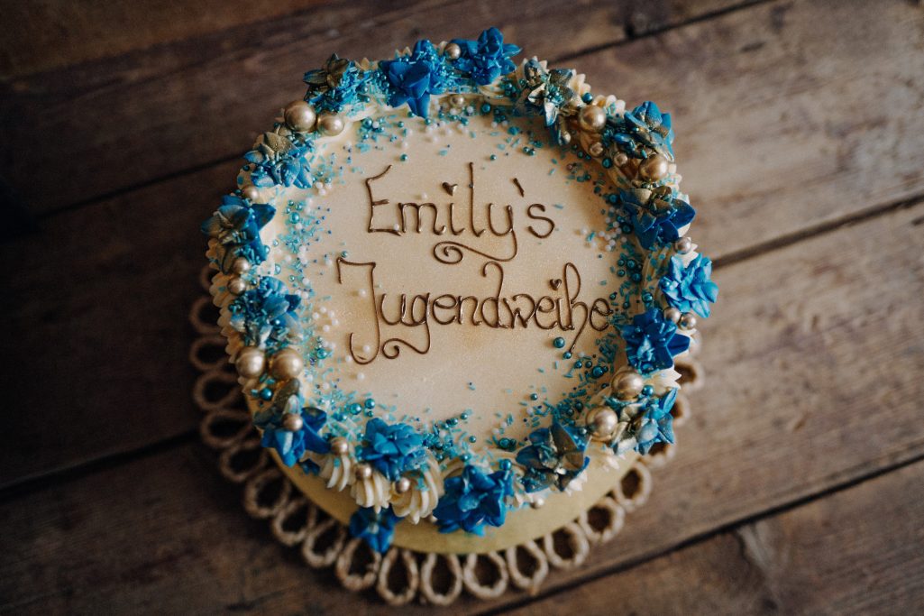 Torte mit blauer und goldener Dekoration, beschriftet mit "Emily's Geburtstag".