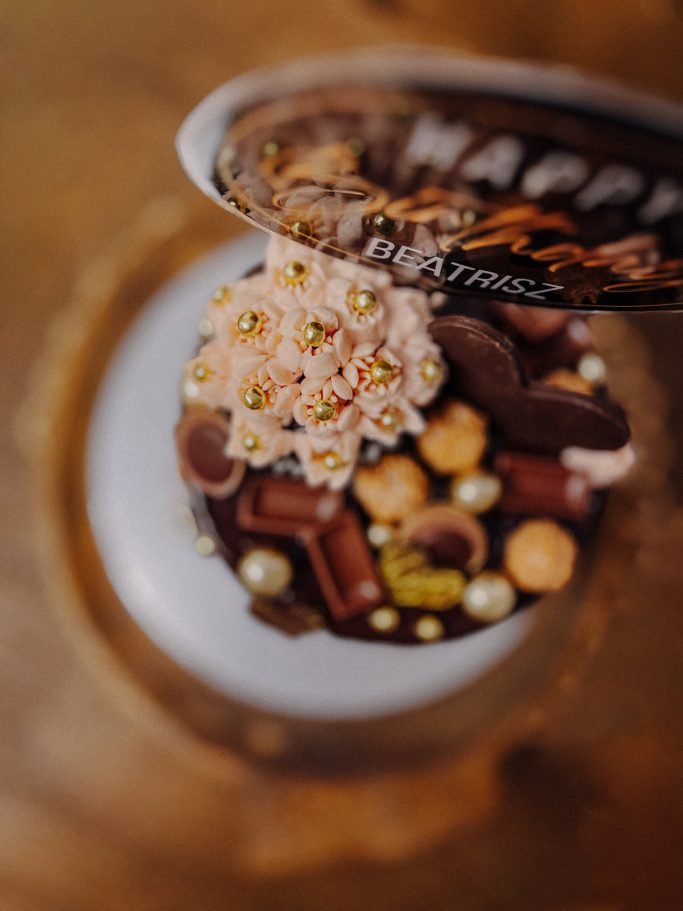 Ein dekorierter Cupcake mit Schokoladenstückchen und bunten Streuseln.